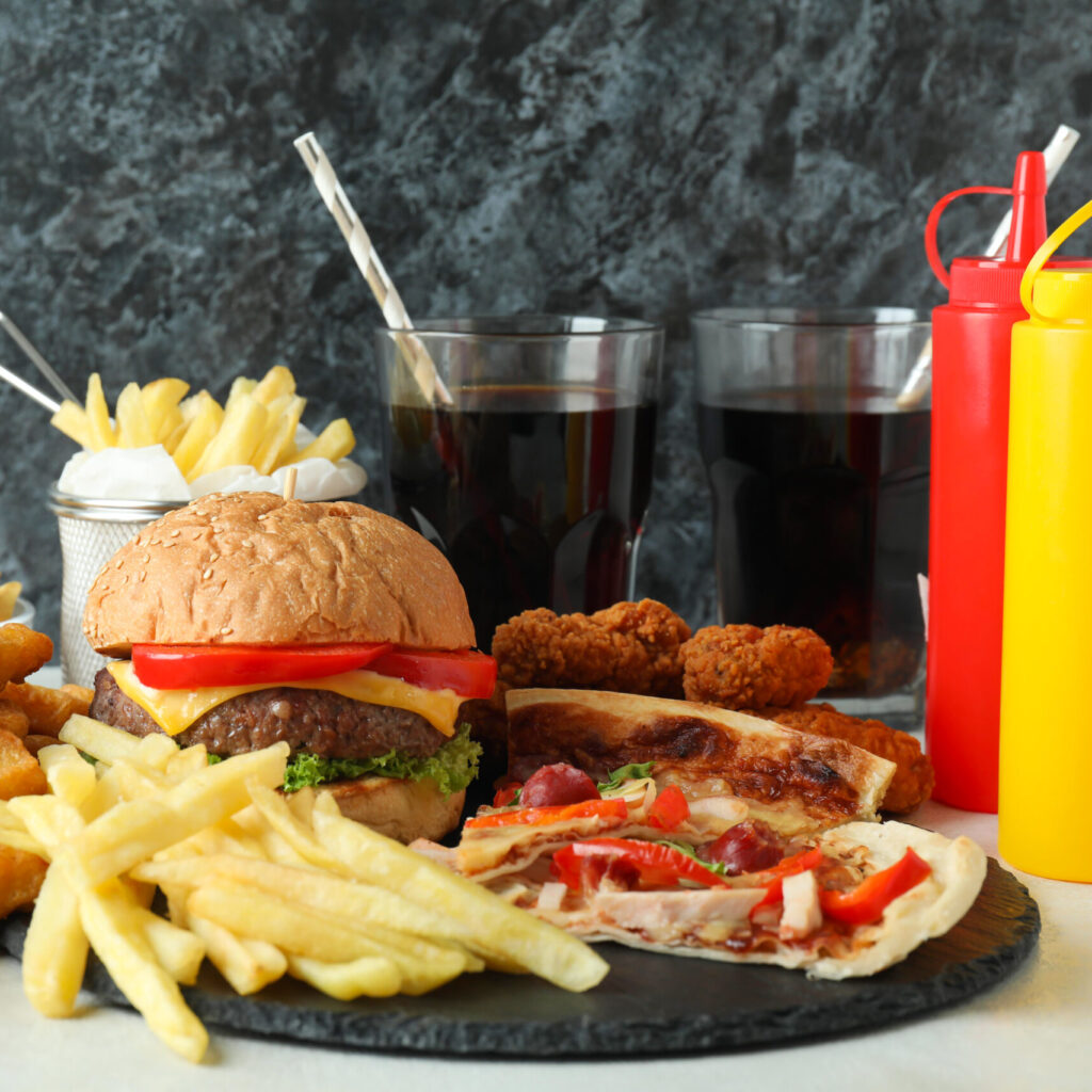 concept of fast food against black smokey background